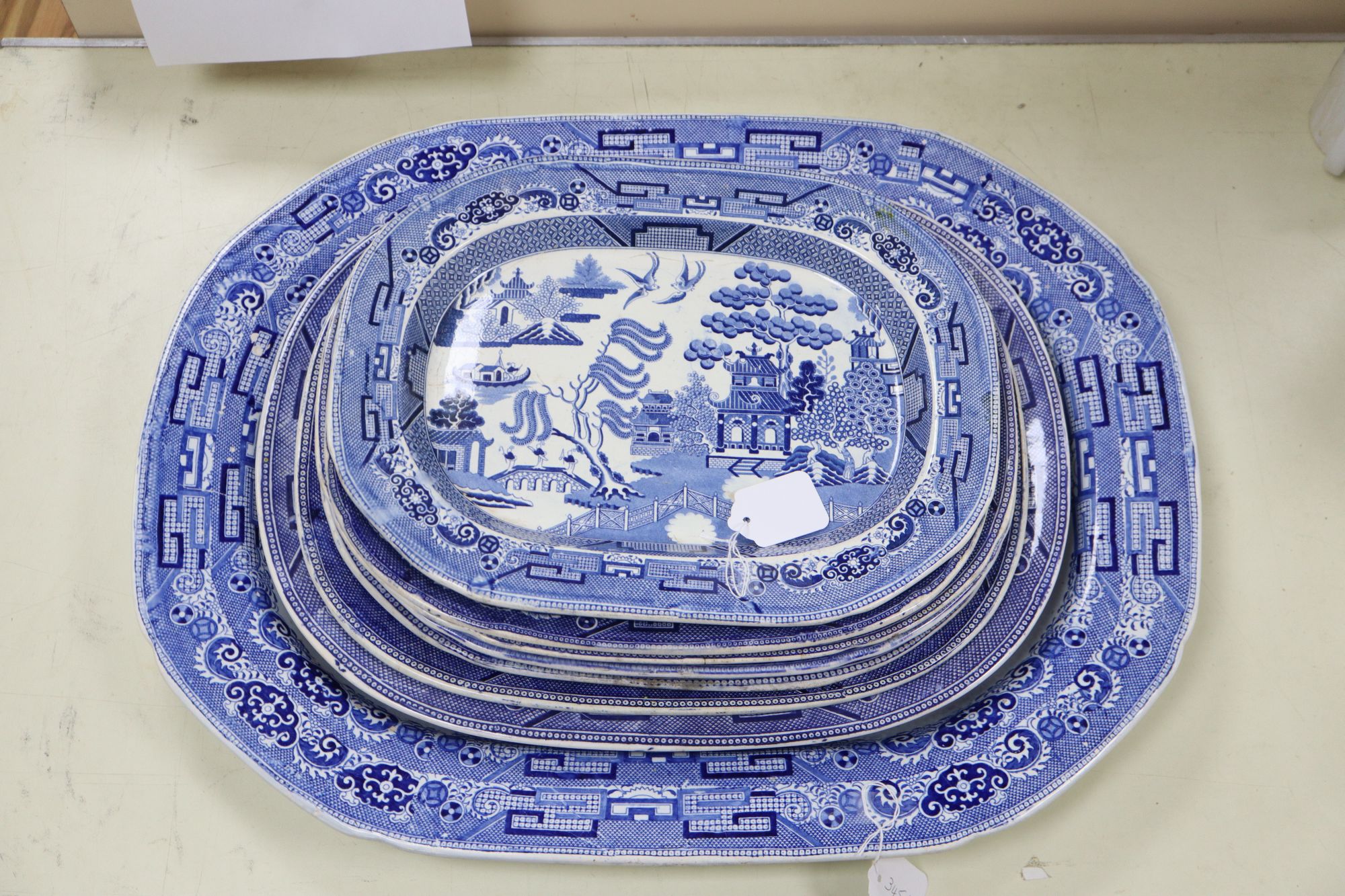 A 19th century transfer-printed large blue and white platter and seven similar smaller platters